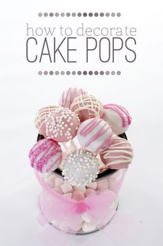 there is a pink and white cake pop in a glass container with the words how to decorate cake pops on it