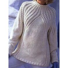 a woman wearing a white sweater and hat in the shape of a cabled turtle neck