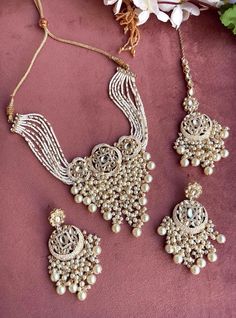 Adorn yourself in timeless elegance with this exquisite ivory white Kundan polki necklace set, perfect for weddings and special occasions. Crafted with meticulous attention to detail, the set features delicate white hues reminiscent of Pakistani and Punjabi traditions, with a touch of Bollywood glamour. Complete with matching earrings and a stunning maangtika, this Indian Kundan ensemble effortlessly captures the essence of sophistication and grace. Measurements:   Necklace Length-14" Necklace Width- 8.5" Earring Length-2" Each earring weighs: 10gms Maangtika Length- 7" Maangtika Width- 1" Luxury Green Bridal Necklace For Diwali, Kundan Polki Necklace, Indian Necklace Set, Punjabi Jewelry, Polki Necklace Set, Bollywood Glamour, Polki Choker, Jewelry Pakistani, Kundan Choker