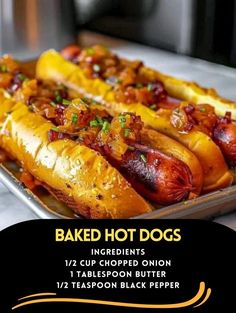 baked hot dogs in buns with toppings on a baking sheet, ready to be eaten