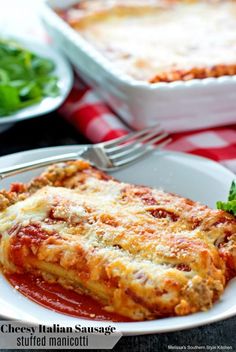 lasagna stuffed with cheese and tomato sauce on a plate next to a salad