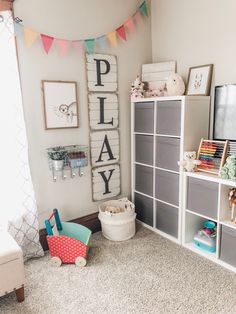 a playroom with toys and bookshelves in it