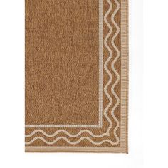 a brown and white rug with an embroidered border on the bottom, in front of a white background