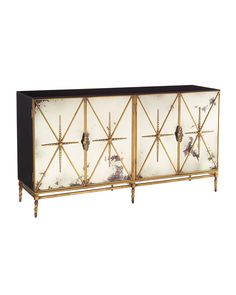 a white and black sideboard with gold trimmings on the doors, in front of a white background