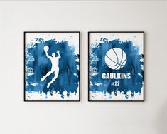 two blue and white paintings with basketballs on them in the corner of a room