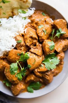 a white plate topped with meat and rice