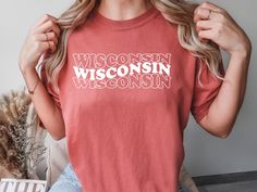 DESCRIPTION The Wisconsin Shirt is printed on a Comfort Colors® 1717 brand. tshirt with a high quality permanent vinyl.  We offer various colors when ordering. Please note that colors may appear slightly different on monitors or with different lighting. Please reference the color chart in the listing. SIZING Shirts are unisex sizing. Please see item photos for a sizing chart. For women, please order your normal numerical size if you are looking for a more regular fit. Note that these already do Relaxed Fit Crew Neck Tops With Heat Transfer Vinyl, Fan Merchandise Short Sleeve T-shirt With Heat Transfer Vinyl, Crew Neck T-shirt With Heat Transfer Vinyl For Fans, Graphic Tee T-shirt With Heat Transfer Vinyl, Casual T-shirt With Heat Transfer Vinyl And Crew Neck, Graphic Tee Shirt With Heat Transfer Vinyl For Fans, Wisconsin Flag, Brand Tshirt, Comfort Colors Shirt