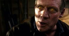 a close up of a person with an evil look on his face and yellow eyes