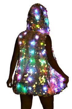 a woman in a dress that has lights all over her body and it's hood up