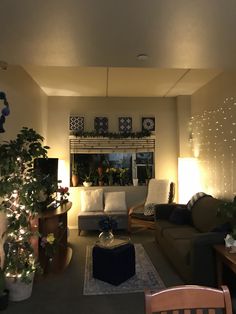 a living room filled with furniture and christmas lights