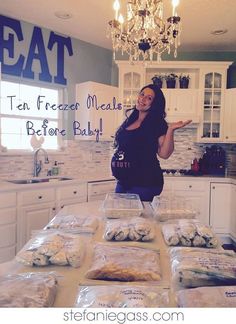 a woman standing in front of a table filled with bags of food