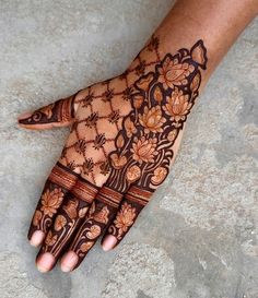 a person's hand is decorated with hennap and floral designs on it