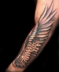 a man's arm with an angel wing and the words tax paid on it