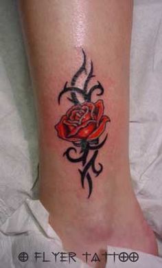 a tattoo on the foot of a woman with a red rose and black outlines