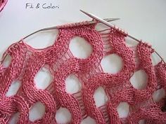 a pink crochet piece with scissors on it