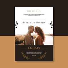 an elegant save the date card with a couple kissing in front of a body of water