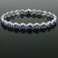 Weight:12.88gr Metal:18kt white gold Stones:24 Sapphires *Cut:Oval *Total Carat Weight:7.39t  Others:312 diamonds *Cut:Round *Total carat weight:2.83ct Condition:New Comments:This ravishing riviere bracelet is made in 18kt white gold. It is adorned with 24 vibrant blue sapphire, each surrounded with brilliant cut diamonds. There is a total carat weight of 7.39ct of sapphires and 2.83ct of diamonds. It is beautiful bracelet and in excellent condition.  Dimensions:Length:  18cm / 7in Width: 6.50mm Oval Diamond Bracelet With Gemstones, Luxury White Gold Sapphire Diamond Bracelet, Formal White Gold Tennis Bracelet With Halo Setting, Luxury Oval Sapphire Tennis Bracelet, Luxury Diamond Bracelet With Halo Setting For Formal Events, Luxury Diamond Bracelet With Halo Setting For Formal Occasions, Luxury Formal Bracelet With Halo Setting, Luxury Formal Bracelets With Halo Setting, Luxury Diamond Bracelet With Halo Setting