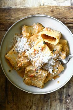 a white plate topped with pasta covered in sauce