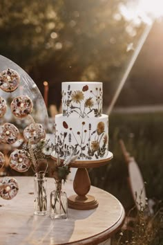 a table topped with a white cake covered in flowers