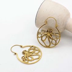 Dive into a world of oceanic charm with our brass octopus earring, featuring a stunning gold Kraken detail that brings a playful yet elegant touch to any outfit. 🎉 Hurry! Purchase within the next 24 hours to get your exclusive offer! Apply this promo code[TRIS1234] and get 38% off. IMPORTANT NOTE....👇 you will also get a surprise gift🎁on every purchase. 💥Explore more unique designs in my shop here:  https://www.etsy.com/shop/bohojwellerybazar Handmade Ocean-inspired Gold Earrings, Nickel Free Gold Ocean-inspired Earrings, Nickel Free Ocean-inspired Gold Earrings, Ocean-inspired Gold Jewelry With Ear Wire, Gold Ocean-inspired Earrings, Octopus Earrings, Brass Hoop Earrings, Hoop Earrings Silver, Brass Hoops