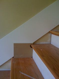 the stairs are made of wood and white paint