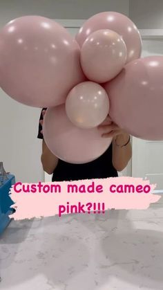 a woman holding pink balloons in front of her face with the caption custom made came pink?