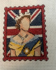 a cross stitch picture of a woman with a british flag on her chest and the words'queen elizabeth '