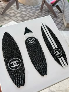 three black and white surfboards sitting on top of a piece of paper next to each other