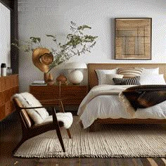 a bed room with a neatly made bed and a chair