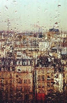 rain drops on the window and buildings in the background