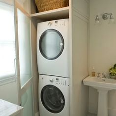 a washer and dryer in a bathroom next to a sink