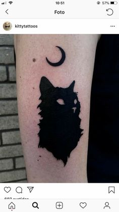 a black cat with a crescent moon tattoo on the arm