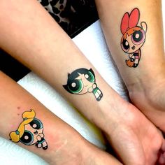 three people with matching tattoos on their arms and feet are sitting next to each other