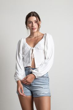 Looking for the More Of This Tie Front Top in Ivory? Shop our latest women’s White Blouses at Tobi! Get a chic look with the More Of This Ivory Tie Front Top. This crop top features an adjustable front tie closure, a front slit, and long sleeves. Bonus: the polyester and spandex material is so soft it feels like you're wearing a cloud. #shoptobi Cotton Tie Front Top, Tie Front Top Outfit, White Tie Front Top, Open Front Top, White Blouses, Tie Front Top, Tie Front Blouse, Sabo Skirt, Chic Look