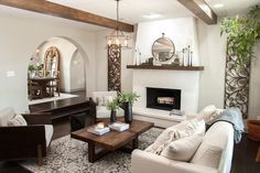 a living room filled with furniture and a fire place in the middle of a room