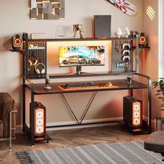 a desk with a computer and speakers on top of it in front of a wall