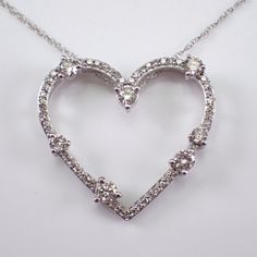 White Gold Diamond Heart Pendant with Chain. This heart is set with fifty-six genuine Round Brilliant Diamonds.  These diamonds are H color, I1 clarity and combine to a total weight of 1/2 carats. This pendant and chain are both 10K White Gold and weigh a total of 2.2 grams. The heart measures 20 X 22 mm. This necklace is accompanied by an appraisal, valued at $1,495.00.  The necklace will be shipped promptly in a gift box. ADDITIONAL REQUESTS If you would like to see more pictures of this item, Gold Simple Necklace, Gold Necklace Simple, Heart Pendant Diamond, Charm Pendant Necklace, Necklace Choker, Fine Jewelry Gift, Diamond Fashion, Simple Necklace, Brilliant Diamond