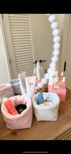 several different types of personal care products on a wooden table in front of a mirror