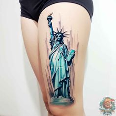 the statue of liberty tattoo is shown on the back of a woman's thigh