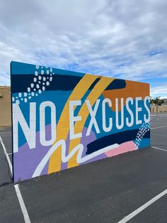 there is a large sign that says no excuses on it in the parking lot