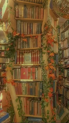 a bookshelf filled with lots of books and flowers