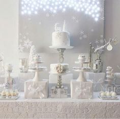 a white table topped with lots of cakes and desserts