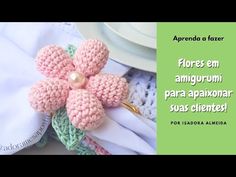 a crocheted flower is sitting on top of napkins and next to a plate