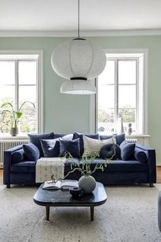 a living room filled with furniture and windows