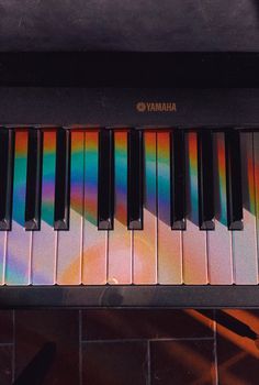 an electronic piano with multicolored keys on it