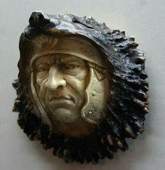 a sculpture of a man with a helmet on it's head is shown in front of a white wall