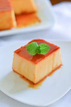 a small piece of cake on a plate with a mint garnish in the center