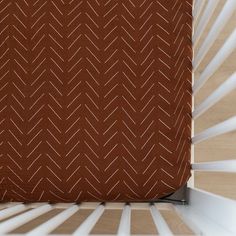 a baby crib with a brown and white pattern on it