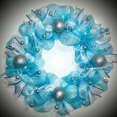 a blue wreath with silver ornaments on it