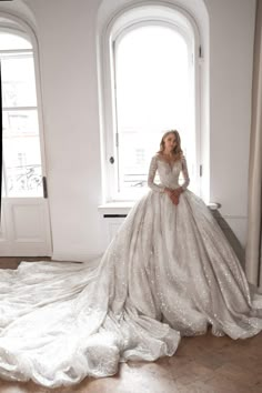 a woman in a wedding dress is posing for the camera